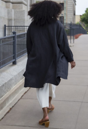 Back view of plus size model wearing Lapel Midi Jacket in Black Linen.