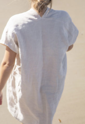 Back view of straight size model wearing Double V Kaftan in Oatmeal Linen.