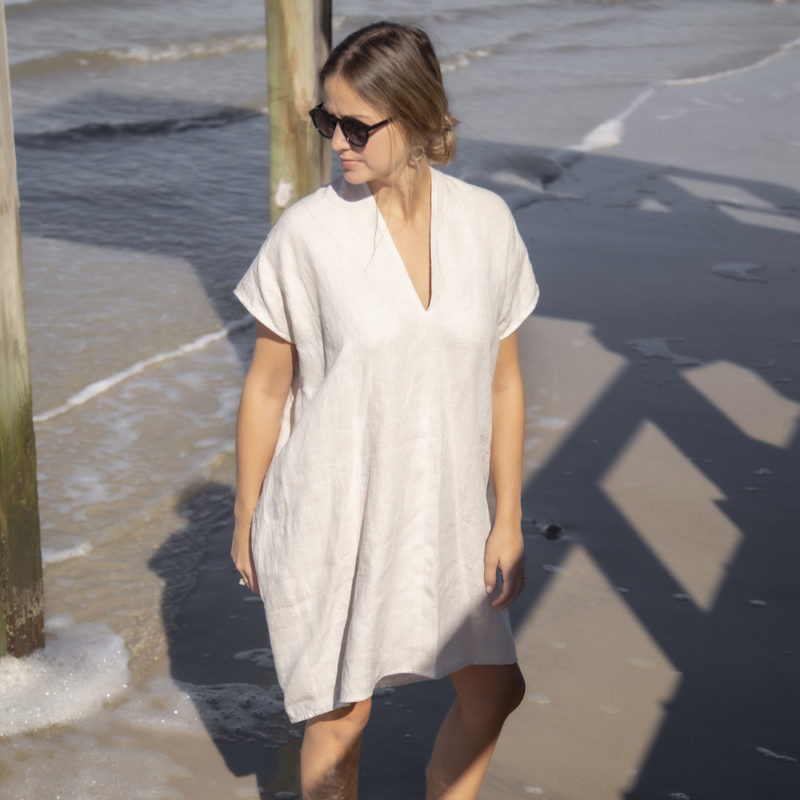 Front view of straight size model wearing Double V Kaftan in Oatmeal Linen.