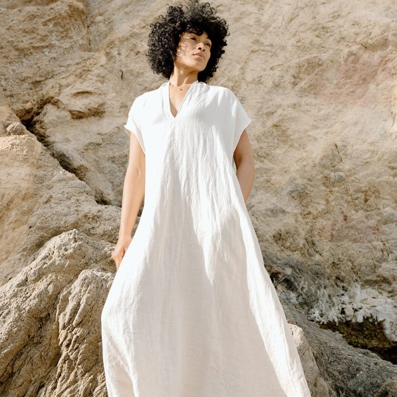 woman on the beach in cream linen v-neck short sleeve midi dress