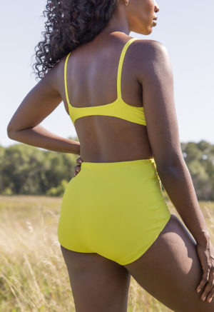 Back view of straight size model in Margarita Rib Retro Fit Bottoms standing in grass.
