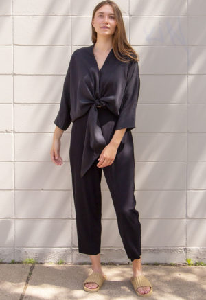Front view of straight size model wearing Black Lyocell Bow Top.