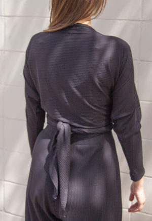 Back view of straight size model wearing Black Rib Everything Top.
