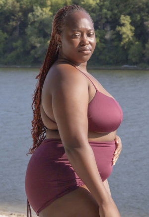 Side view of plus size model wearing Fig Ruched Top.