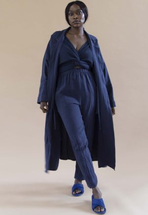 Woman in navy blue linen pants, blue rib top and navy blue linen lapel midi jacket