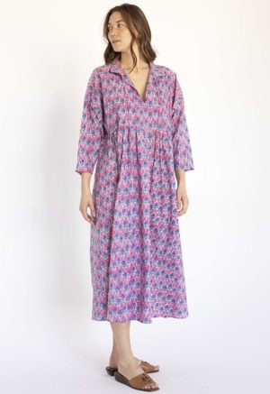 women wearing pink floral oversized dress with dolman sleeves, collar and ties at neck