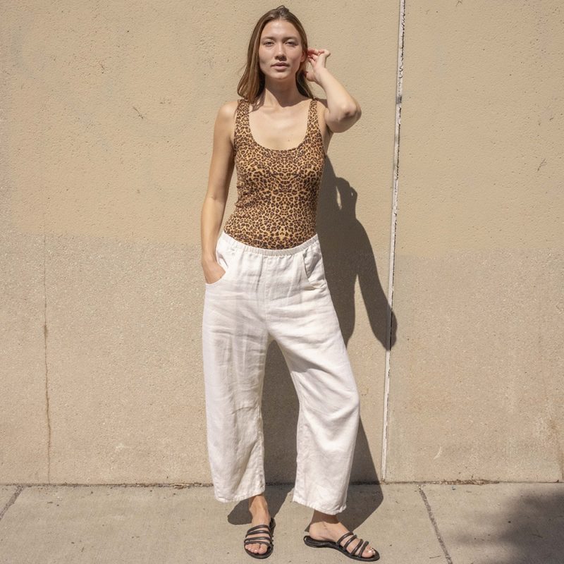 woman in leopard print scoop tank and white low rise baggy pants