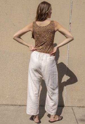 woman in leopard print scoop tank and white low rise baggy pants