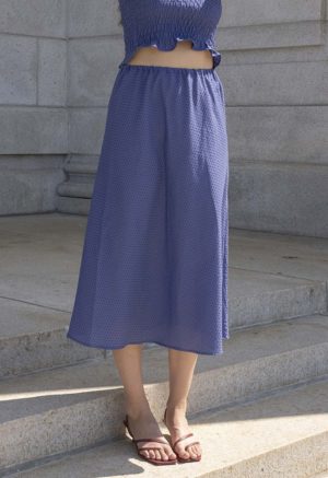 woman in hazy blue slip skirt and matching tube top