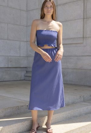 woman in hazy blue slip skirt and matching tube top