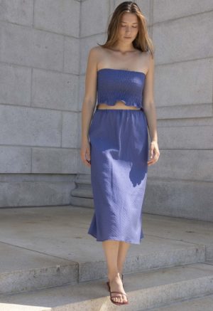 woman in hazy blue slip skirt and matching tube top