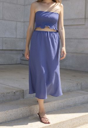 woman in hazy blue slip skirt and matching tube top