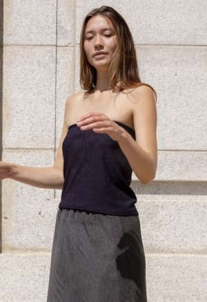 woman in black tube top and green sheer slip skirt