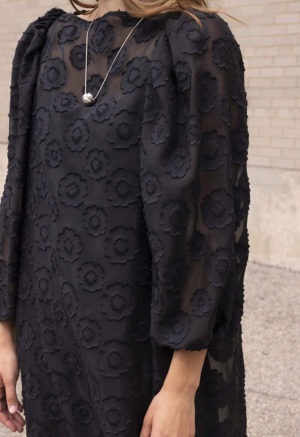 woman in black sheer floral dress