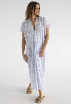 woman in midi length white cotton kaftan