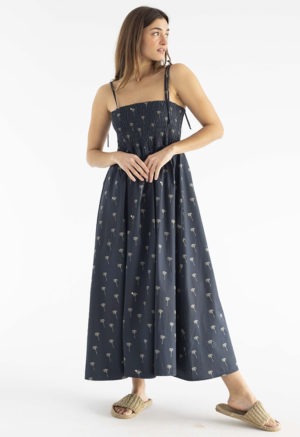 women in black spaghetti strap sundress with palm tree print