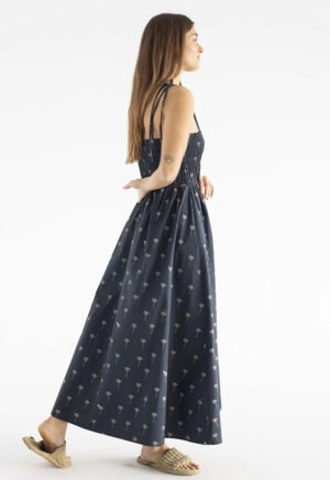 women in black spaghetti strap sundress with palm tree print