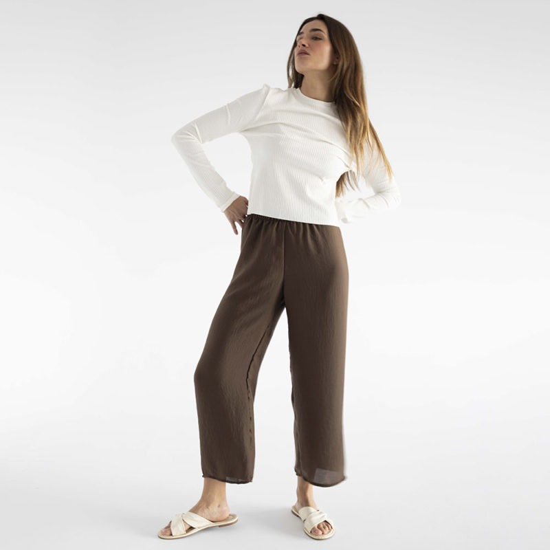 woman in brown wide-leg pants and white rib long sleeve top