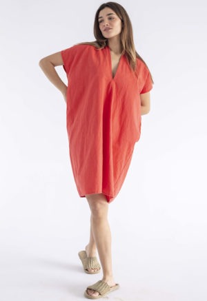 woman in bright poppy red v-neck, knee length dress