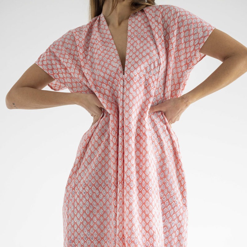 woman in pink floral kaftan