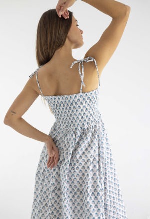 women in white and teal floral sundress