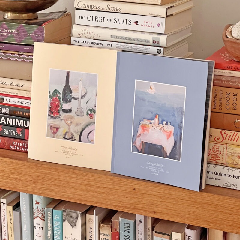 yellow and blue book sitting on bookshelf