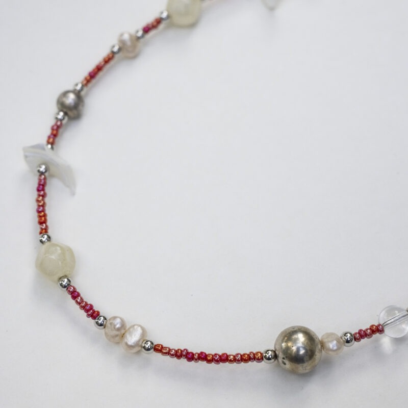 small red beaded necklace with pearls and shells