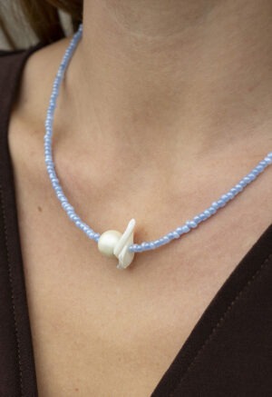 woman in blue pearl and shell necklace