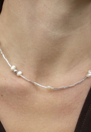 pearl and silver necklace on woman