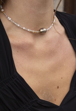 woman in black dress and beaded necklace
