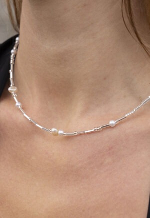 Woman in pearl and silver necklace