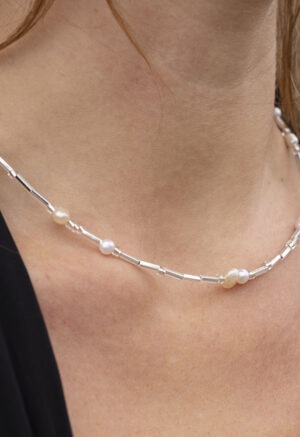 Woman in pearl and silver necklace