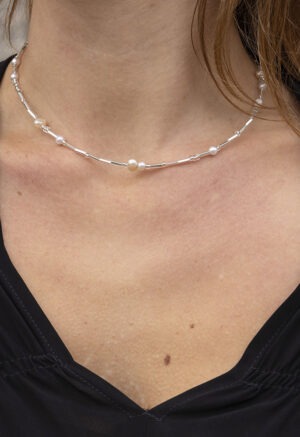 Woman in pearl and silver necklace