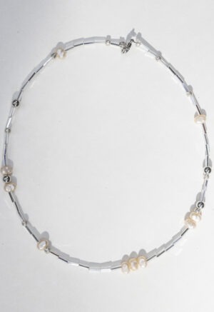 pearl and silver necklace on white backdrop