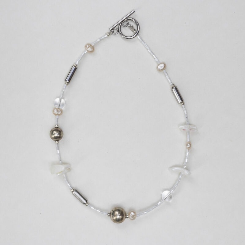 White and silver necklace of various jems