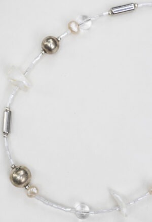 White and silver necklace of various jems