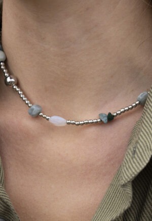 silver and rock necklace on woman
