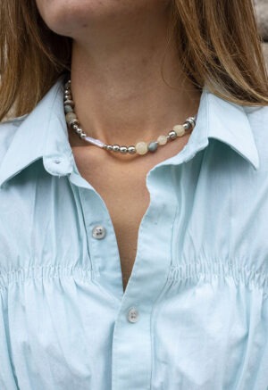 woman in silver, pearl, rock necklace