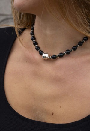 woman in black dress with black necklace