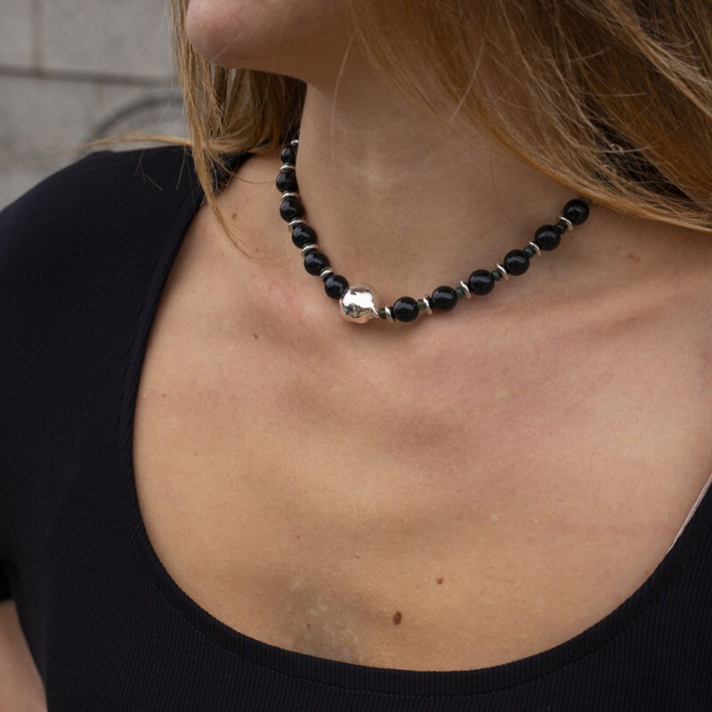 woman in black dress with black necklace