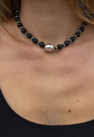woman in black dress with black necklace
