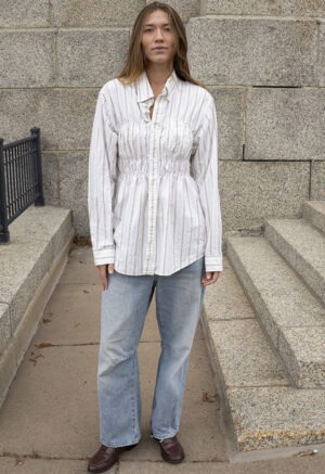 woman in white stripe button-up and jeans