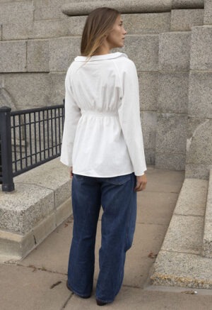 woman in white shirt and blue jeans