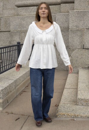 woman in white shirt and blue jeans