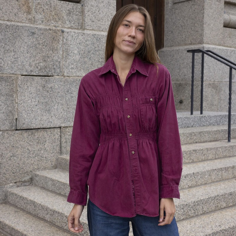 woman in maroon shirt and jeans