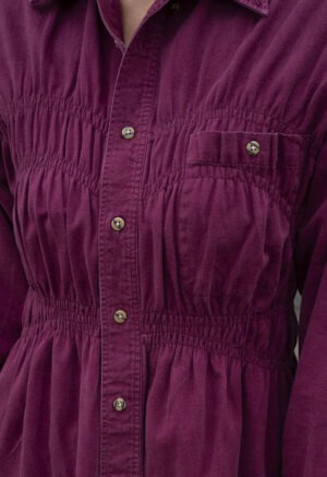 woman in maroon shirt and jeans