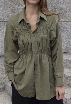 woman in green shirt and black pants
