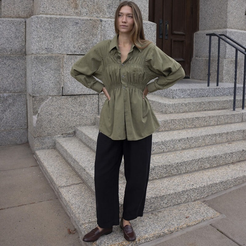 woman in green shirt and black pants