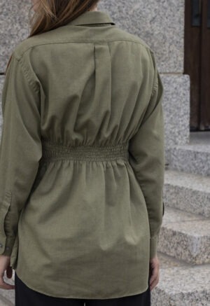 woman in green shirt and black pants