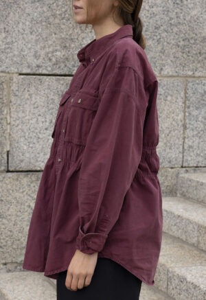 woman in maroon button-up and black trousers